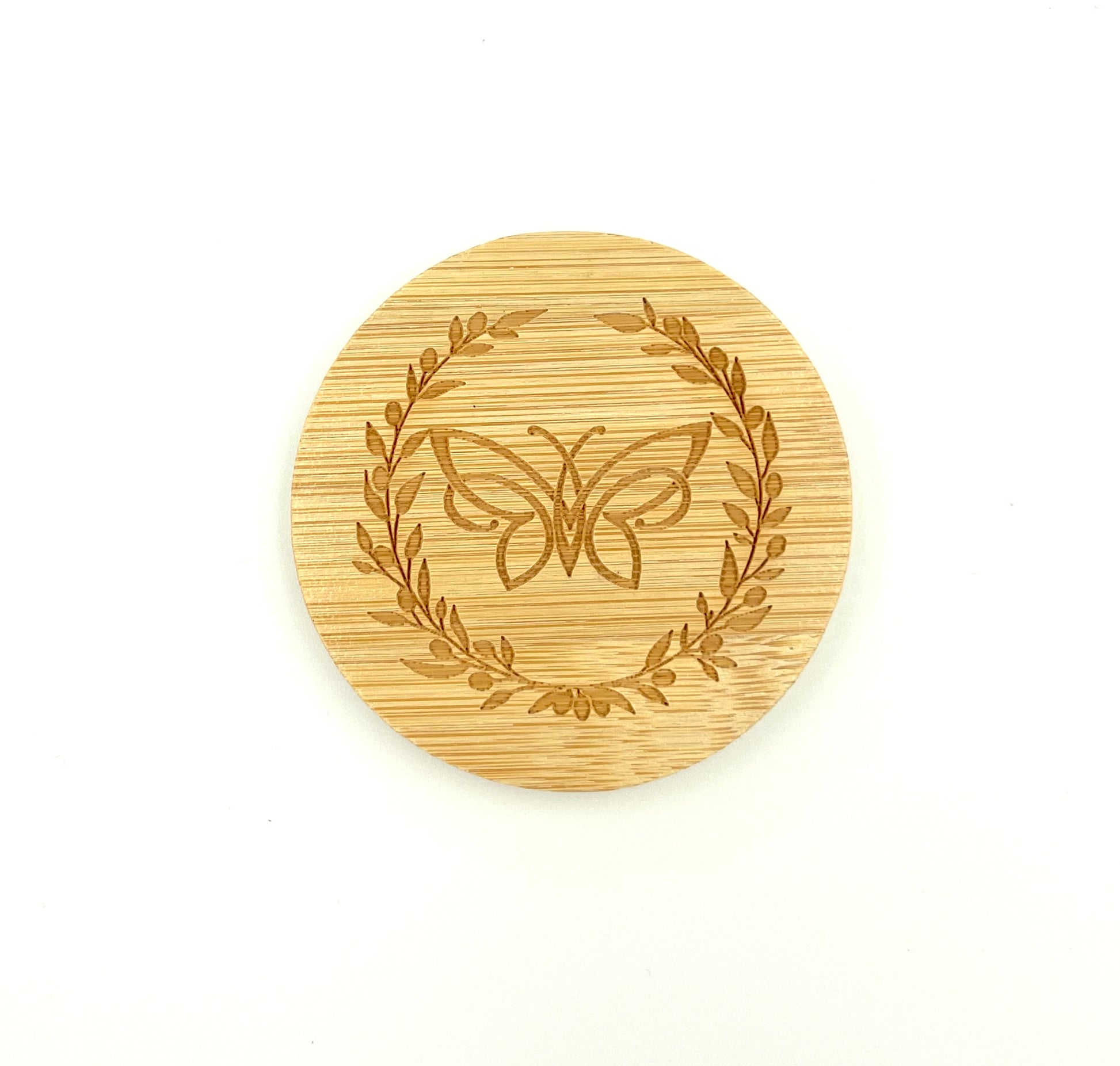 Bamboo mirror with engraved butterfly and olive wreath design on a white background