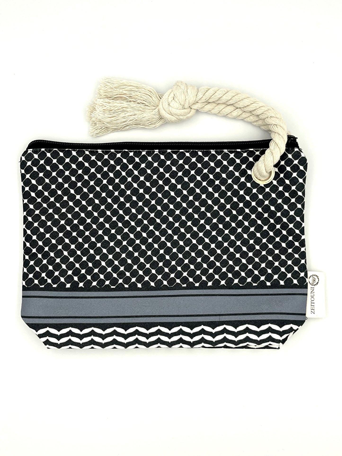 Black makeup bag with beige rope against a white background. Bag is designed with a keffiyeh pattern on the pouch and a ZEITOUNI logo tag. 